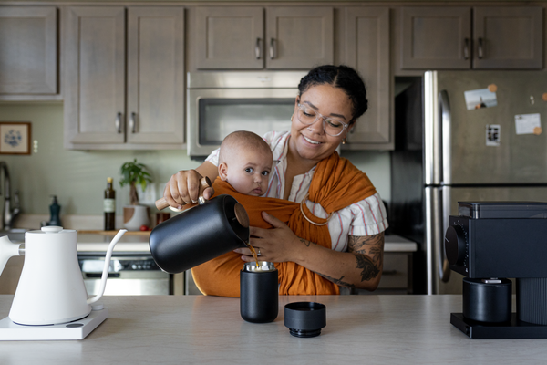 Mom pouring coffee into the Fellow Carter Move Mug